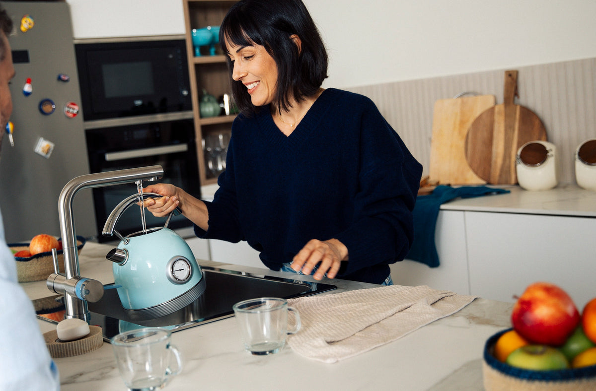 BRITA 3-way rectangular kitchen tap filling a kettle with water.
